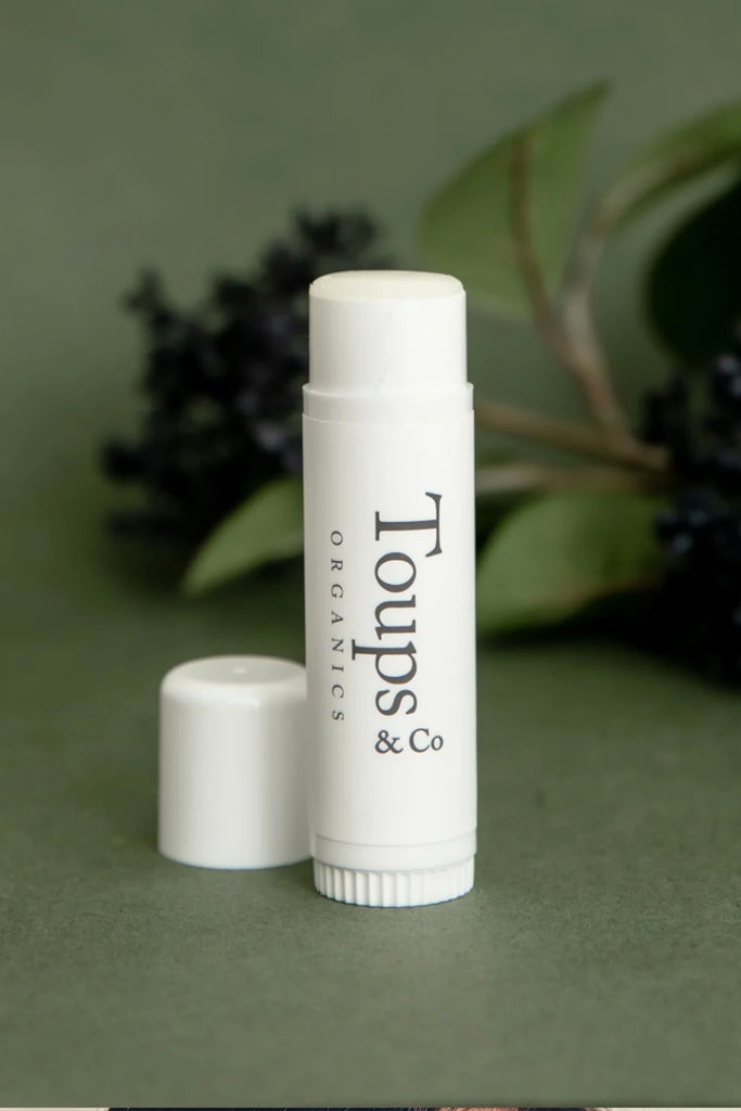 Toups & Co lip balm with green background